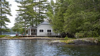 Deep Charcoal Interlock Cedar Shingle aluminum roof on a white home with a metal roof on a waterfront property, Winderemere, Ontario