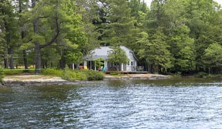 Deep Charcoal Interlock Cedar Shingle aluminum roof on a cottage on a lake surrounded by trees, Winderemere, Ontario