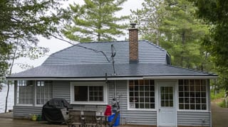 Deep Charcoal Interlock Cedar Shingle aluminum roof on a grey cottage with a metal roof on a lake surrounded by, Winderemere, Ontario