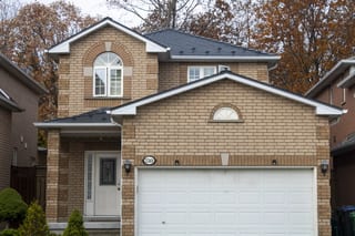 Deep Charcoal Interlock Cedar Shingle aluminum roof on a two-storey colonial home with a deep charcoal metal roof, Mississauga, Ontario