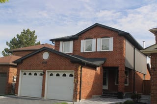 Deep Charcoal Interlock Slate aluminum roof on a red brick two-storey home with dormers in a suburban, Mississauga, Ontario