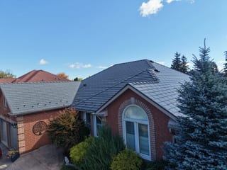 Musket Grey Interlock Cedar Shingle aluminum roof on a brick home with a gable roof in a suburban neighbourhood, Brampton, Ontario