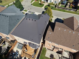 Tudor Brown Interlock Cedar Shingle aluminum roof on a Tudor brown metal roof on a two-storey brick home in an, Oakville, Ontario
