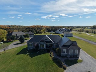 Black Interlock Slate aluminum roof on a ranch-style home with a black metal roof in a forested, Blackstock, Ontario