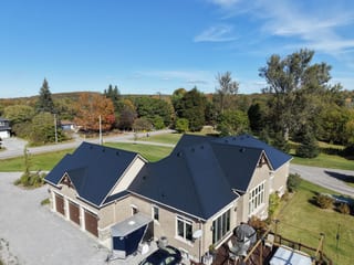Black Interlock Slate aluminum roof on a tan home with a black metal roof in a rural setting with, Blackstock, Ontario