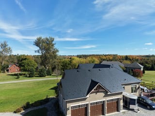 Black Interlock Slate aluminum roof on a tan ranch style home with a black metal roof in a, Blackstock, Ontario
