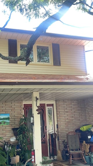 Copper Penny Interlock Slate aluminum roof on a tan two-storey home with dormers in a rural suburban, Oshawa, Ontario