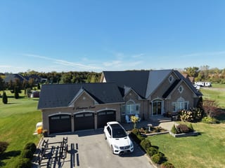 Black Interlock Slate aluminum roof on a brown single-family home with a metal roof on a rural, Kawartha Lakes, Ontario