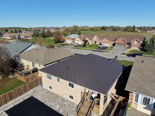 Tudor Brown Interlock Slate aluminum roof on a Tudor brown ranch-style home in a rural subdivision, Lindsay, Ontario