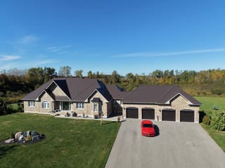 Tudor Brown Interlock Slate aluminum roof on a Tudor brown metal roof on a ranch style home in the forest, Kawartha Lakes, Ontario