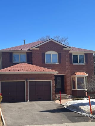 Aged Copper Interlock Shingle aluminum roof on a red brick two-storey home with dormers in a rural setting, Orléans, Ontario