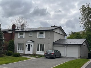 Colonial Brown Interlock Shingle aluminum roof on a Colonial brown metal roof on a two-storey house among, Ottawa, Ontario