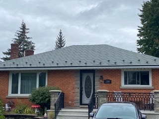 Hunter Green Interlock Slate aluminum roof on a red brick one-storey home with a metal roof, Ottawa, Ontario