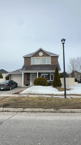 Tudor Brown Interlock Slate aluminum roof on a brown Tudor home with dormers in a snowy suburban, Orléans, Ontario