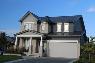 Black Interlock Slate aluminum roof on a two-storey home with a black metal roof in a rural, Carleton Place, Ontario