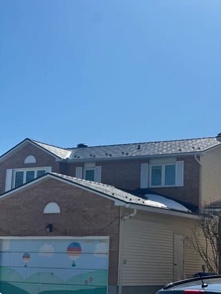 Black Interlock Slate aluminum roof on a brown two-storey home with dormers in a suburban setting, Orléans, Ontario
