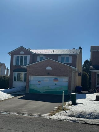 Black Interlock Slate aluminum roof on a two-storey brick home with a metal roof in a suburban, Orléans, Ontario