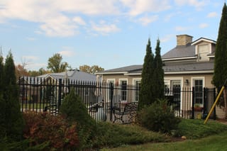 Deep Charcoal Interlock Slate aluminum roof on a tan home with a metal roof in a rural setting, Carleton Place, Ontario