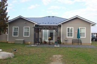 Deep Charcoal Interlock Slate aluminum roof on a beige ranch home with a metal roof in a rural suburb, Carleton Place, Ontario