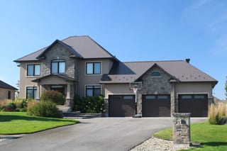 Tudor Brown Interlock Cedar Shingle aluminum roof on a Tudor brown two-storey home with dormers in a suburban, Greely, Ontario