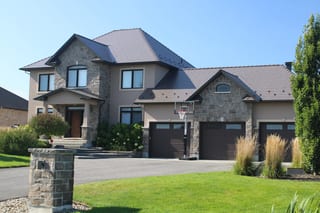 Tudor Brown Interlock Cedar Shingle aluminum roof on a Tudor Brown colonial home with a two-car garage in a, Greely, Ontario