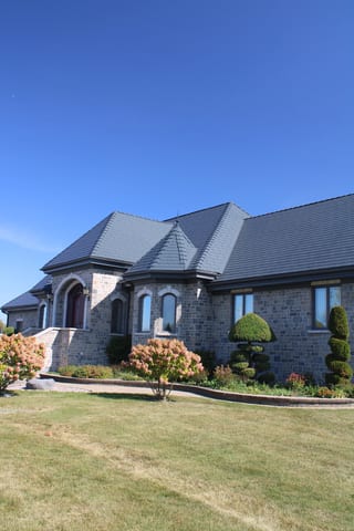 Deep Charcoal Interlock Slate aluminum roof on a deep charcoal metal roof on a colonial style home in a, Alexandria, Ontario