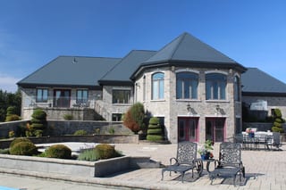 Deep Charcoal Interlock Slate aluminum roof on a single-storey home with stone facade and metal roof, Alexandria, Ontario