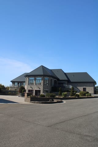 Deep Charcoal Interlock Slate aluminum roof on a modern single-storey home with a metal roof in a rural, Alexandria, Ontario