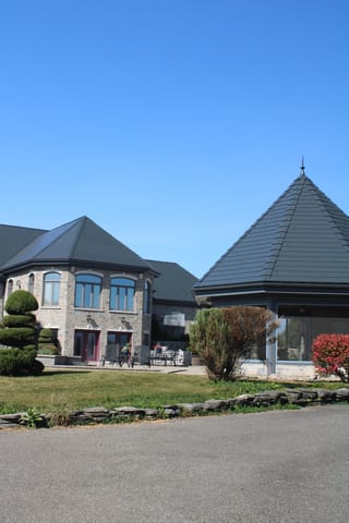 Deep Charcoal Interlock Slate aluminum roof on a Deep Charcoal Interlock Slate roof on a two-storey stone, Alexandria, Ontario