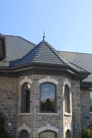 Deep Charcoal Interlock Slate aluminum roof on a modern single-family home with a deep charcoal metal roof, Alexandria, Ontario