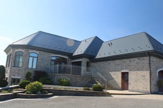 Deep Charcoal Interlock Slate aluminum roof on a tan brick home with a metal roof in a rural setting, Alexandria, Ontario