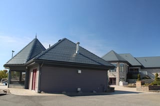 Deep Charcoal Interlock Slate aluminum roof on a modern home with a metal roof and grey siding in a, Alexandria, Ontario