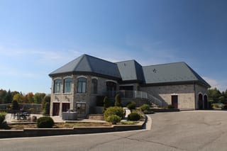 Deep Charcoal Interlock Slate aluminum roof on a colonial home with a slate roof on a forested rural lot, Alexandria, Ontario