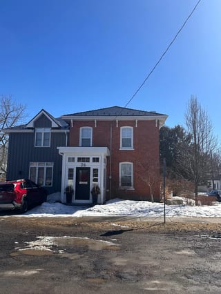 Black Interlock Slate aluminum roof on a red brick home with a metal roof in a rural setting, Prince Edward, Ontario