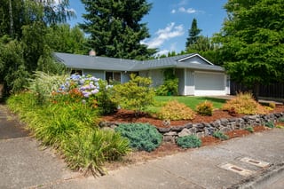 Charcoal Grey Interlock Shingle aluminum roof on a grey ranch style home with a metal roof in a forested, Hillsboro, Oregon