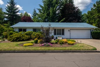 Charcoal Grey Interlock Shingle aluminum roof on a ranch-style home with a grey metal roof in a forested, Hillsboro, Oregon