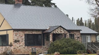 Black Interlock Cedar Shingle aluminum roof on a brown single-storey cottage with a metal roof in a rural, Hood River, Oregon