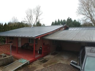 Deep Charcoal Interlock Standing Seam aluminum roof on a Deep Charcoal metal roof on a one-storey home in the woods, Scio, Oregon