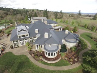 Deep Charcoal Interlock IB Membrane aluminum roof on a single-family home with a metal roof in a forested rural, Turner, Oregon