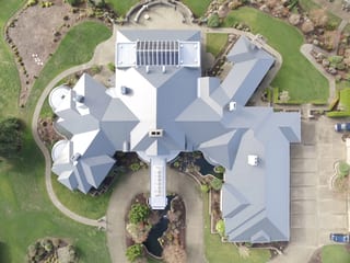 Deep Charcoal Interlock IB Membrane aluminum roof on a large metal roofed home in rural Oregon, Turner, Oregon