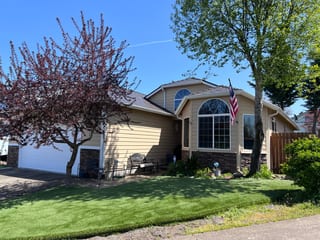 Front-left view of a 1.5-story ranch home in Molalla OR with Interlock Tudor Brown cedar shingle aluminum roofing over a multi-hip profile.