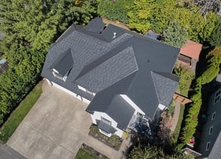 Deep Charcoal Interlock Shake aluminum roof on a Deep Charcoal Interlock Shake metal roof on a white, Portland, Oregon