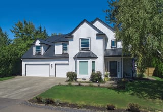 Deep Charcoal Interlock Shake aluminum roof on a white colonial home with a metal roof in a forested, Portland, Oregon