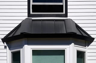 Deep Charcoal Interlock Shake aluminum roof on a Deep Charcoal Interlock Shake metal roof on a white, Portland, Oregon