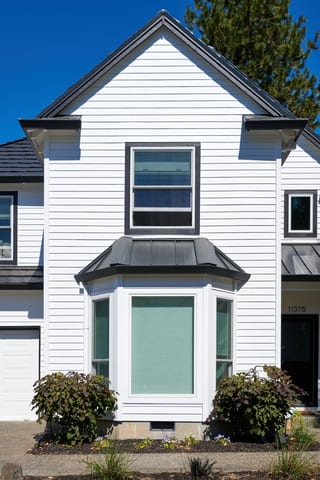 Deep Charcoal Interlock Shake aluminum roof on a white modern house with a metal roof in a suburban, Portland, Oregon