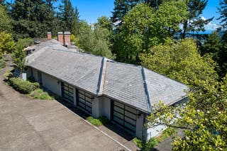 Before: a natural slate roof with broken tiles on the home, Portland, Oregon, ahead of a Deep Charcoal Interlock Slate aluminum roof