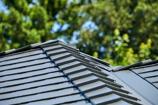 Deep Charcoal Interlock Slate aluminum roof on a Deep Charcoal Interlock Slate metal roof on a white, Portland, Oregon