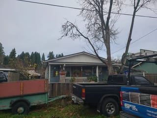 Musket Grey Interlock Slate aluminum roof on a grey two-storey home with a gable roof in a forested, Clackamas Clackamas Clackamas Clackamas, Oregon