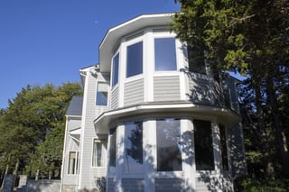 Deep Charcoal Interlock Slate aluminum roof on a colonial home with a metal roof in a forested rural, Warwick, Rhode Island