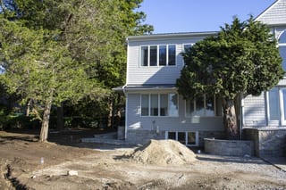 Deep Charcoal Interlock Slate aluminum roof on a white two-storey Colonial with a slate metal roof in a, Warwick, Rhode Island